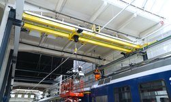 Overhead travelling crane with electric chain hoist over railway wagon