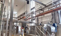 Stainless steel crane system in cheese factory A workplace in food production is equipped with a rust-resistant suspension crane