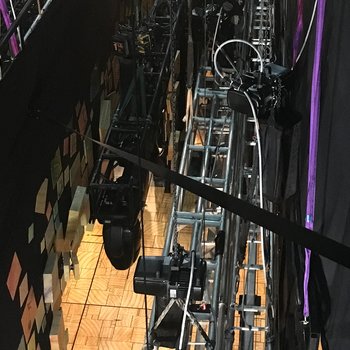 Climbing hoists hold truss with loudspeaker and spotlight