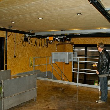 A plastic container is gently lifted by the GIS electric chain hoist and transported from the ground floor to the stage on the ground floor.