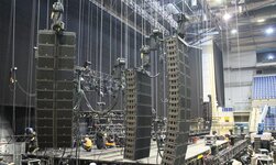 Electric chain hoists during stage construction Climbing hoists LP hold loudspeaker system during construction of a concert stage