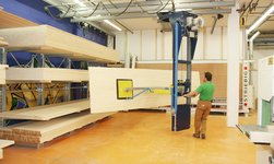 Crane system for the efficient storage and retrieval of panels and pallets in the warehouse