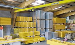 Underslung travelling crane with electric chain hoist in warehouse